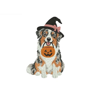 May include: An embroidered design of an Australian Shepherd dog wearing a black witch hat with a pink ribbon. The dog has a tri-colour coat of white, brown, and grey, and is holding an orange jack-o'-lantern candy bucket in its mouth.