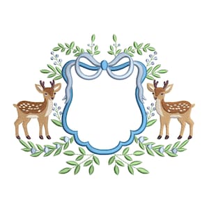 May include: An embroidered design featuring two deer flanking a blue frame with a bow at the top. The deer are brown with white spots. Green leaves and blue berries surround the frame, creating a decorative border.