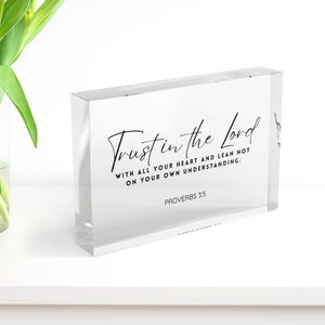 May include: A clear acrylic block with the text "Trust in the Lord" in elegant script. The block also includes the scripture "With all your heart and lean not on your own understanding. Proverbs 3:5."