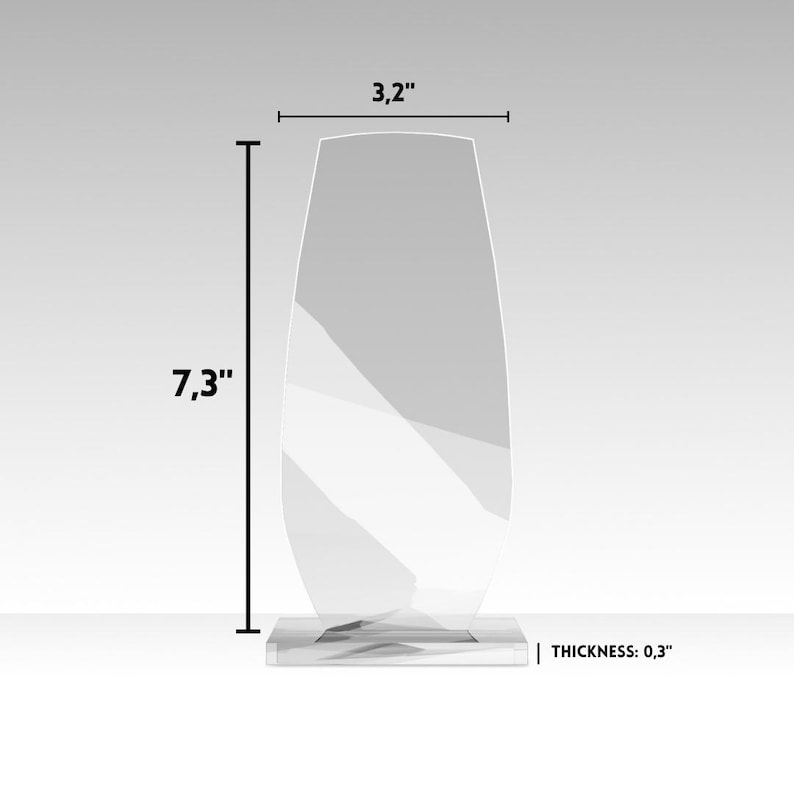 May include: A clear, oval-shaped glass award with a rectangular base. The award is 7.3 inches tall, 3.2 inches wide, and 0.3 inches thick. The text "THICKNESS: 0.3" is visible.