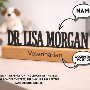 May include: A wooden desk nameplate with the name "DR. LISA MORGAN" in black letters. Below the name, the word "Veterinarian" is engraved. The text "HEIGHT: DEPENDS ON THE LENGTH OF THE TEXT" is also visible.