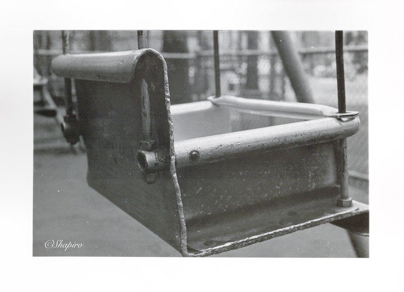 Peut inclure: Une balan&ccedil;oire en m&eacute;tal noir avec un si&egrave;ge rectangulaire. La balan&ccedil;oire est en m&eacute;tal et a un design simple.