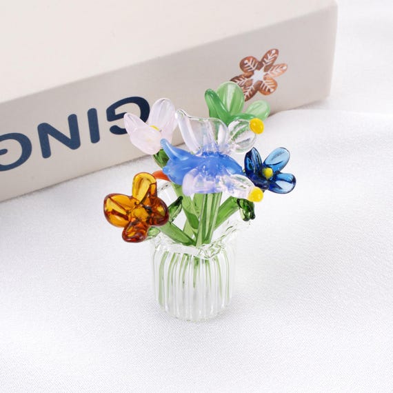Tiny hand-torched borosilicate glass flower bouquets that look impossibly delicate — real flamework craft you genuinely can't find at a big-box store.