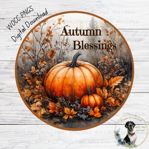 Könnte beinhalten: Ein rundes Aquarellbild einer Herbstlandschaft mit zwei Kürbissen, Blättern und dem Text "Autumn Blessings".