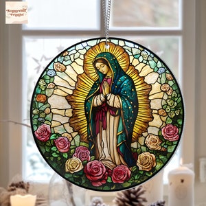 May include: A stained glass round ornament featuring a depiction of the Virgin Mary in a blue robe with a gold halo, surrounded by pink and white roses.