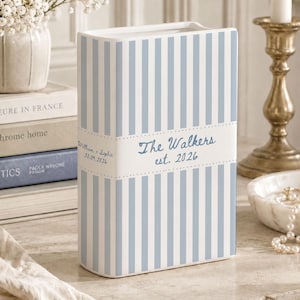 May include: A rectangular ceramic vase featuring vertical light blue and white stripes. A central white horizontal band displays the text "The Walkers est. 2026" in blue, with "William + Sophie 10.09.2026" printed on the side panel in blue script.