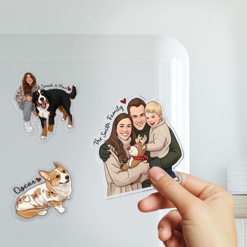 May include: Custom family portrait magnets featuring a family of three with a reindeer, a woman with a Bernese Mountain Dog, and a Corgi. The family magnet has the text "The Smith Family". The dog magnets have the names "Oscar" and "Sarah & Max".