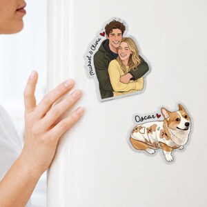 May include: Clear acrylic magnets featuring a couple and a dog. The couple magnet shows a smiling man and woman embracing, with the names "Michael & Olivia" and a heart. The dog magnet features a Corgi named "Oscar" with a heart.