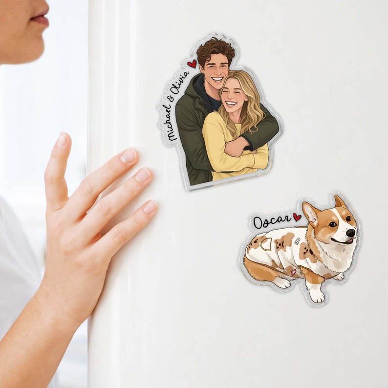 May include: Clear acrylic magnets featuring a couple and a dog. The couple magnet shows a smiling man and woman embracing, with the names "Michael & Olivia" and a heart. The dog magnet features a Corgi named "Oscar" with a heart.