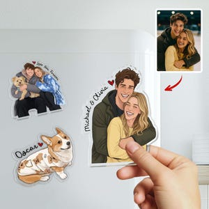 May include: A collection of personalized magnets featuring cartoon illustrations of couples and a dog. One magnet shows a couple with the text "Michael & Olivia" and a heart. Another magnet has the text "Love You Forever". A third magnet shows a dog with the name "Oscar".