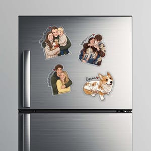 May include: A collection of custom family portrait stickers and a corgi sticker are displayed on a stainless steel refrigerator. The family portrait stickers feature couples and families with names written on them. The corgi sticker has the name "Oscar" on it.