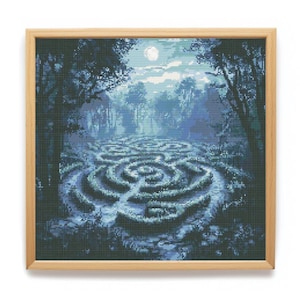 May include: A square cross-stitch embroidery depicting a dark blue and teal hedge maze under a full moon, framed in a light-colored wooden border. The scene features dense trees surrounding the labyrinth with a bright moon in the night sky.