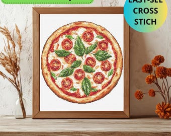 May include: A framed cross stitch pattern of a pizza with red tomato slices, green basil leaves, and white cheese. The pattern is titled "Easy-See Cross Stich".
