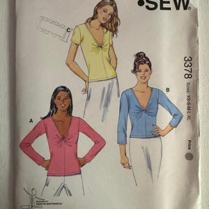 May include: Kwik Sew pattern 3378 for misses' sizes XS-S-M-L-XL. The envelope features illustrations of three tops with V-necklines and front-twist details. Style A has long sleeves, style B has three-quarter sleeves, and style C has short sleeves.