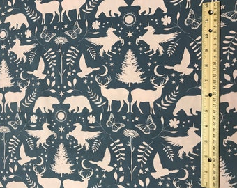 May include: A seamless fabric pattern featuring a repeating design of white unicorns, deer, bears, and trees on a dark blue background. The pattern also includes butterflies, stars, and crescent moons.