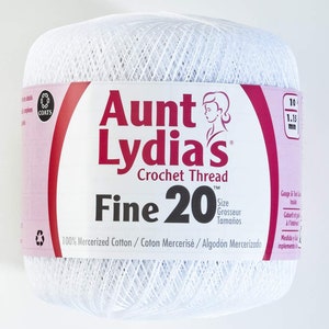 May include: A white ball of Aunt Lydia's Crochet Thread, Fine 20 size. The label features the brand name in red, a woman's silhouette, and the text "100% Mercerized Cotton." The thread is 1.15 mm thick.