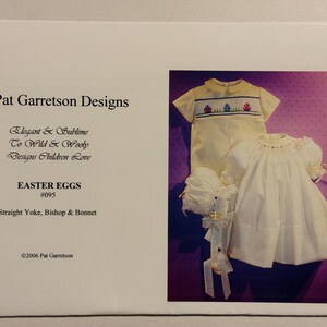 May include: A sewing pattern for a baby's Easter outfit. The pattern includes a bishop dress, a bonnet, and a straight yoke. The pattern is called "Easter Eggs #095" and is by Pat Garretson Designs.
