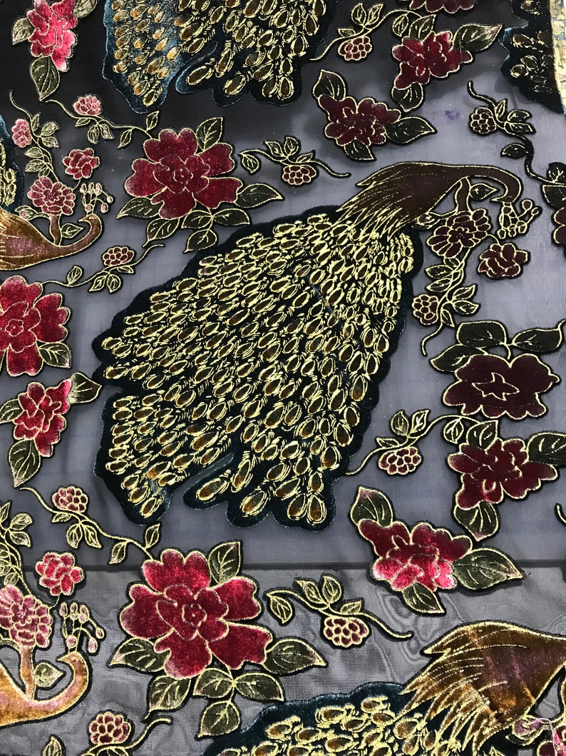 May include: Black sheer fabric with a gold and burgundy floral pattern. The fabric features peacocks with gold and black feathers.