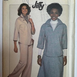 May include: Simplicity pattern 8169 featuring two women modeling outfits. One woman wears a beige pantsuit, and the other a blue and white checkered top and skirt. The pattern is size 14.