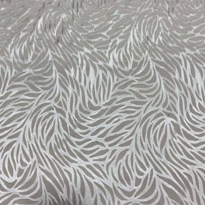 May include: White fabric with a silver embossed pattern of swirling leaves.