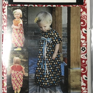 May include: A sewing pattern for a dress called "Retro Mae" by Jane Mckinlay Cluff. The pattern features a vintage design for a little girl's dress. The pattern includes three photos of young girls wearing the dress.