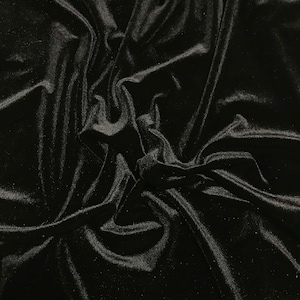 May include: Black velvet fabric with a soft, smooth texture. The fabric is draped and folded, creating a luxurious and elegant look.