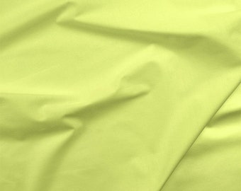 May include: A piece of light green fabric with a smooth texture. The fabric is folded and wrinkled, creating a soft and flowing look.