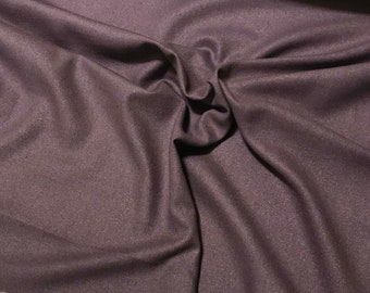 May include: A close-up of a piece of dark purple fabric with a subtle shimmer. The fabric is soft and has a smooth texture.