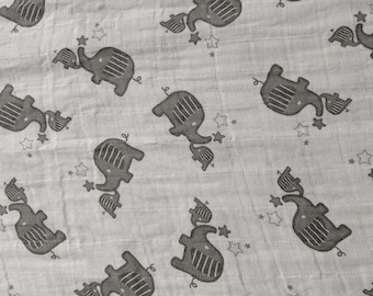 May include: A gray and white fabric with a repeating pattern of black elephants. The elephants are in different sizes and are holding stars.