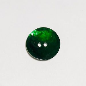 May include: A green iridescent button with two holes.