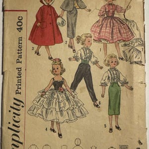 May include: Vintage Simplicity doll pattern, size 18 inches. The pattern features illustrations of dolls in various outfits, including a red coat, a plaid suit, a pink dress, a black and white dress, and pants and a skirt.