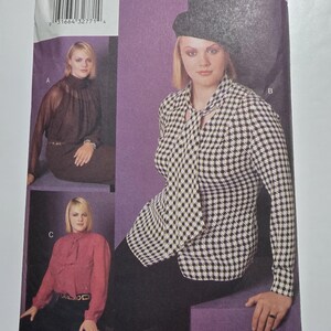 May include: A vintage sewing pattern from Mode Magazine Collection. The pattern features three women modeling different blouses and tops. The pattern size is 14W-16W-18W. The cover has a purple background and the text "Women's Sizes 14W to 30W".