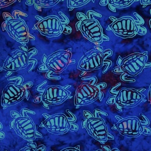 May include: A blue fabric with a repeating pattern of teal sea turtles. The turtles are stylized and have a batik-like appearance.