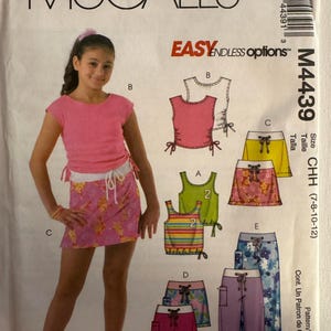 May include: McCall's sewing pattern M4439 for girls' clothing. The pattern includes options for tops, skirts, shorts, and pants. The image shows a girl wearing a pink top and floral skirt. The pattern size is CHH (7-8-10-12).