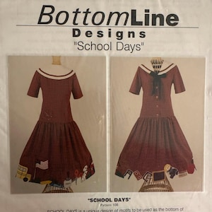 May include: A sewing pattern envelope titled BottomLine Designs School Days featuring two illustrations of a maroon plaid dress with a white sailor collar and school-themed motifs along the hem, including a yellow bus, flag, and various school supplies.