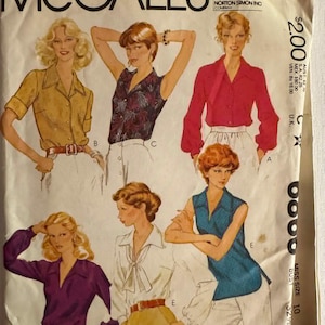 May include: A vintage McCall's sewing pattern envelope featuring illustrations of five different blouse styles. The designs include long-sleeved and sleeveless tops in yellow, dark floral, red, purple, white, and blue colors, with various collar and tie details.