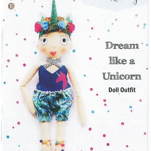 May include: A doll outfit for a doll with a unicorn horn, a flower crown, a blue and white striped top, blue shorts with a floral pattern, and gold shoes with pom-poms. The outfit is called "Dream like a Unicorn Doll Outfit" and coordinates with the Willow Dress Me Doll Pattern, sold separately.
