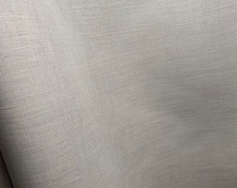 May include: Close-up of a smooth, light gray fabric with a subtle woven texture.