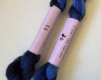 May include: Two skeins of blue and navy blue French wool yarn. Each skein is wrapped with a light purple label that reads "16" and "37 yards 100% virgin wool". The yarn is overdyed and appears soft and fluffy.