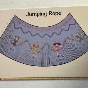 May include: Illustration of a jumping rope design with four cartoon figures holding the rope. The text "Jumping Rope" is at the top. The rope design is blue with pink and red accents.