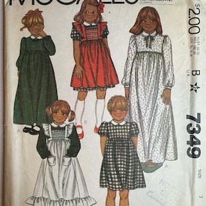 May include: Vintage McCall's sewing pattern featuring illustrations of girls' dresses. The pattern includes various dress styles, with details like collars, sleeves, and skirt designs. The pattern is marked with the number 7349 and the size 7.