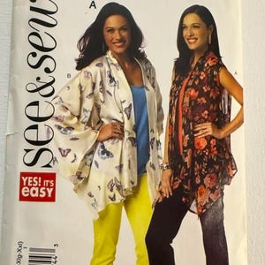 May include: A sewing pattern titled "See & Sew" with the number B5839. The pattern features two women modeling different outfits. One outfit includes a butterfly-print kimono, yellow pants, and a blue top. The other outfit includes a floral print top and black pants.