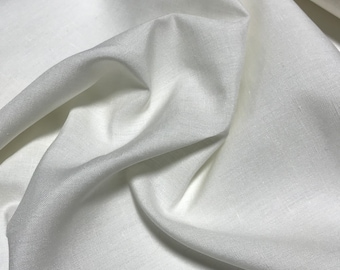 May include: White linen fabric with a smooth, slightly textured surface. The fabric is folded and draped, showing its soft, flowing texture.