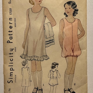 May include: Vintage Simplicity Pattern 1709, size 4, featuring illustrations of girls' sleepwear designs. The pattern includes a nightgown with a ruffled hem and a romper. The cover is aged with text including "New York" and "Paris."