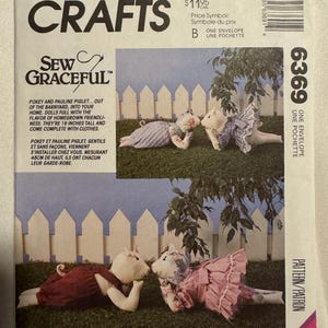 May include: McCall's Crafts pattern featuring instructions for making two piglet dolls, each 19 inches tall, with clothes. The pattern includes the text "Sew Graceful" and the price.