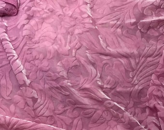 May include: A pink velvet fabric with a floral embossed pattern. The fabric has a soft, plush texture.