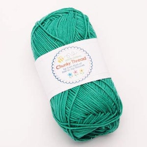 May include: A ball of teal blue 100% cotton yarn labeled "Chunky Thread by Lori Holt of Bee in My Bonnet".