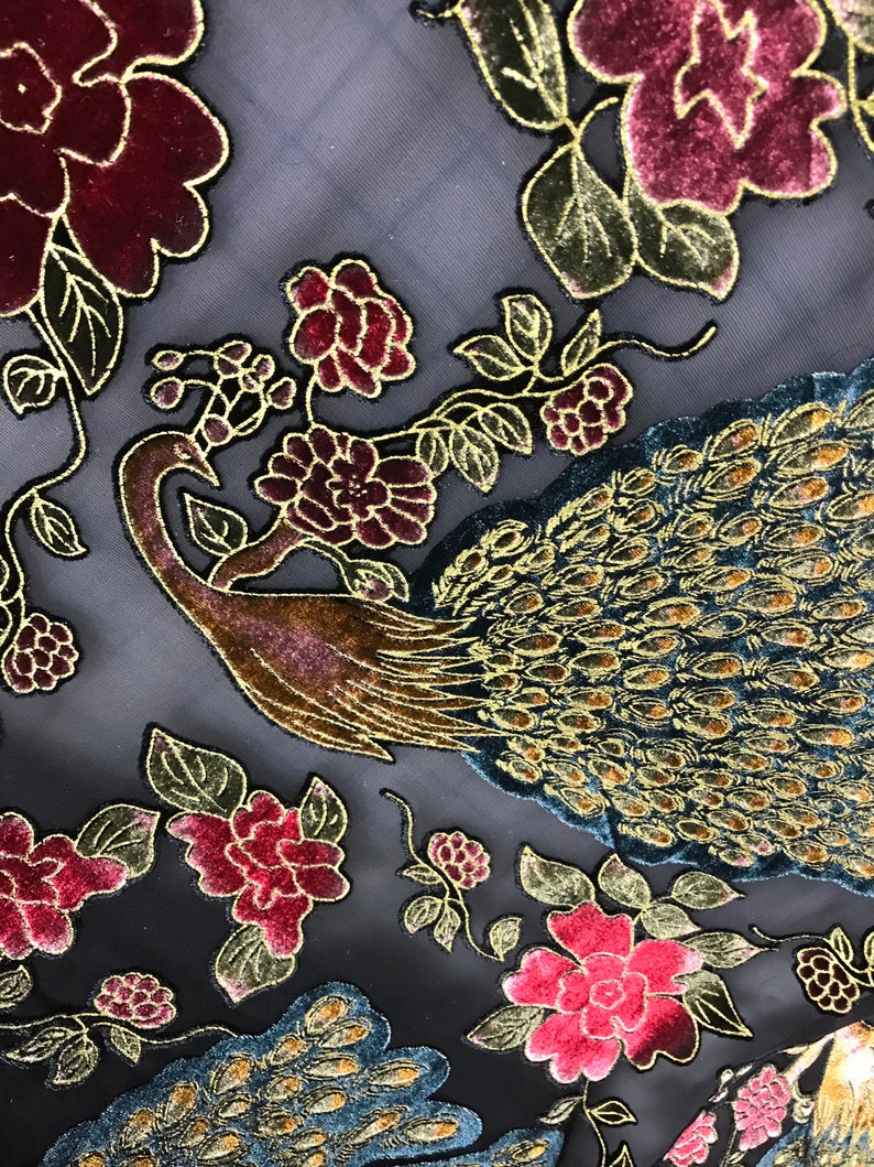 May include: Black sheer fabric with a gold and teal peacock design and burgundy velvet flowers.