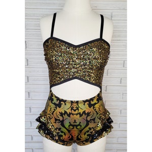 May include: A black and gold sequined dance leotard with a cut-out design and a ruffled bottom.