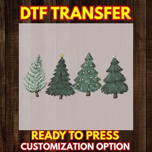 May include: A DTF transfer sheet featuring four illustrated Christmas trees on a light background. The text DTF TRANSFER, READY TO PRESS, and CUSTOMIZATION OPTION is visible. The trees include a snowy one, one with a star, one with ornaments, and one with a snowflake topper.